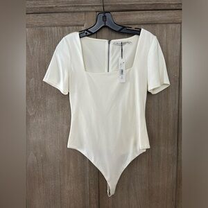 This is an Alice + Olivia short sleeve bodysuit in white size M